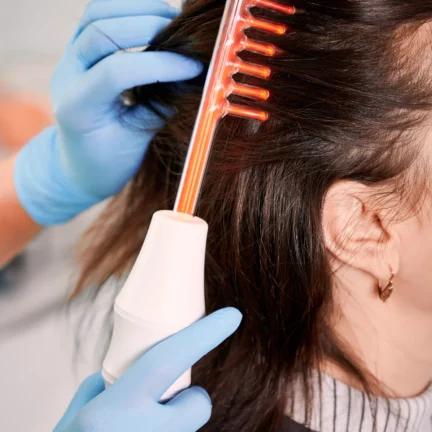 hair-specialist-brushing-woman-hair-with-laser-comb