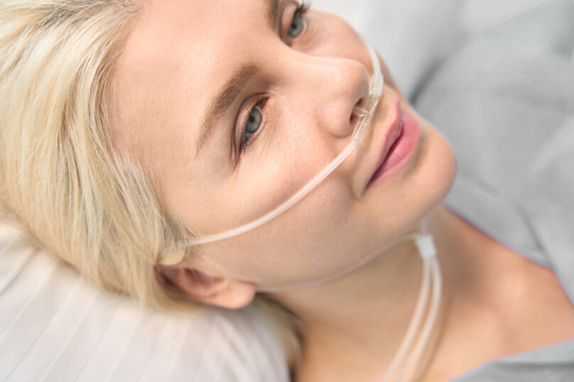 Closeup of unrecognizable woman posing against a white studio background. One female only feeling c.
