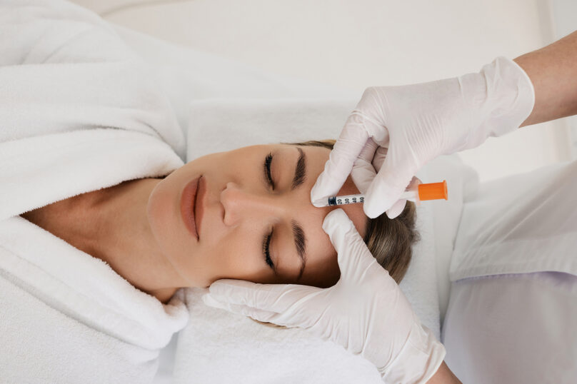 Closeup of unrecognizable woman posing against a white studio background. One female only feeling c.