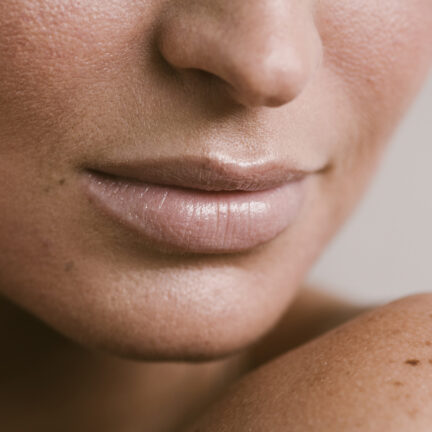 Closeup of unrecognizable woman posing against a white studio background. One female only feeling c.