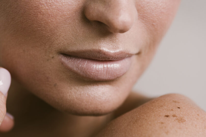 Closeup of unrecognizable woman posing against a white studio background. One female only feeling c.