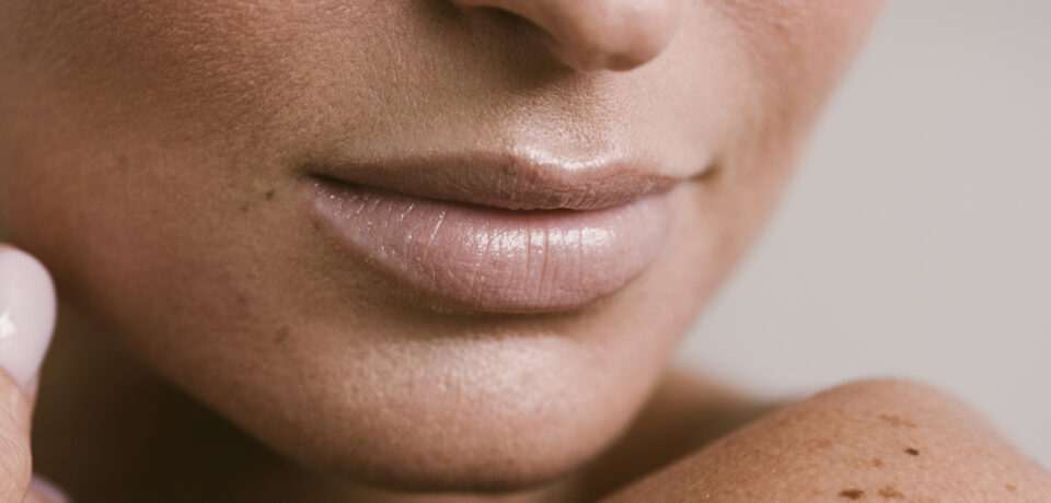 Closeup of unrecognizable woman posing against a white studio background. One female only feeling c.